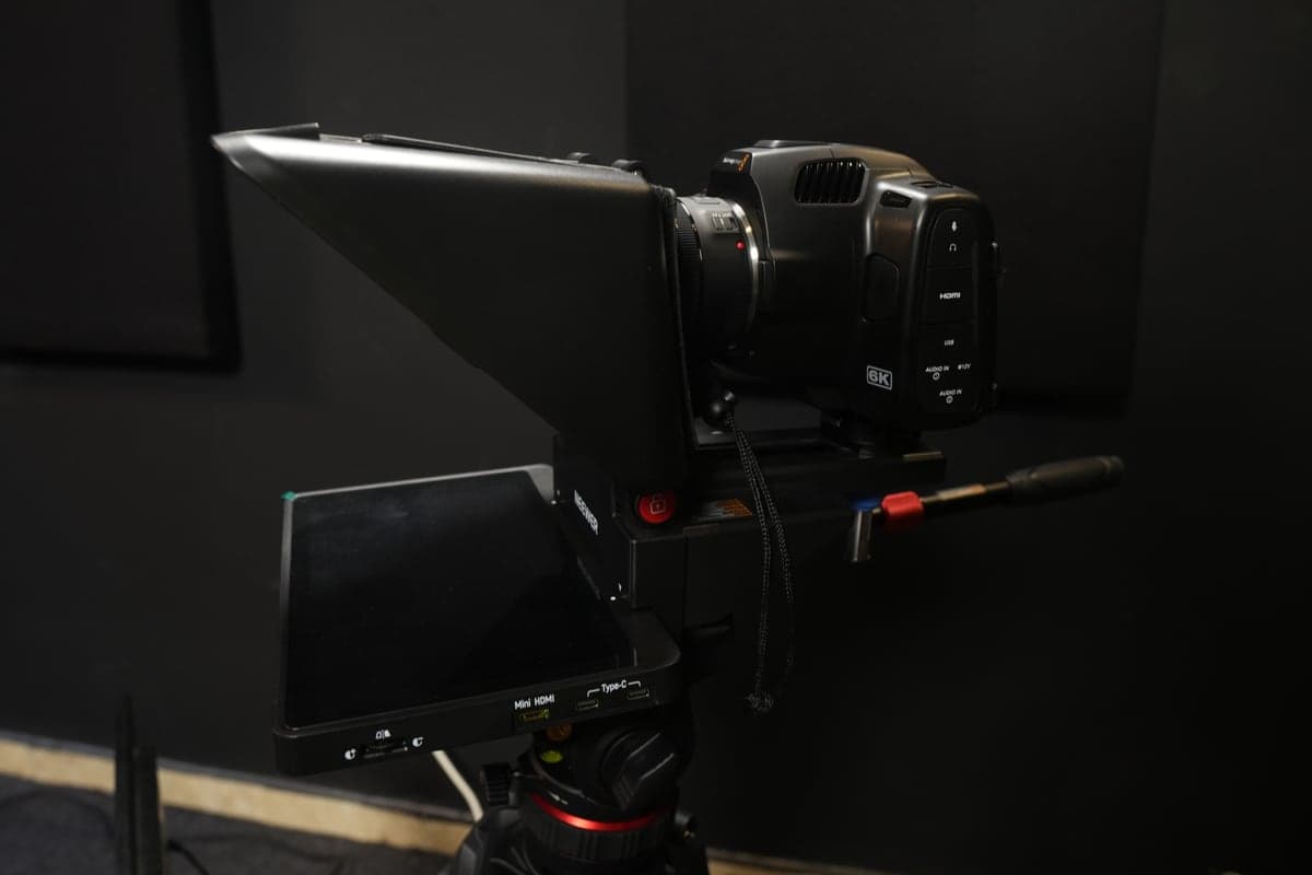 A Blackmagic Pocket 6K cinema camera mounted behind a teleprompter