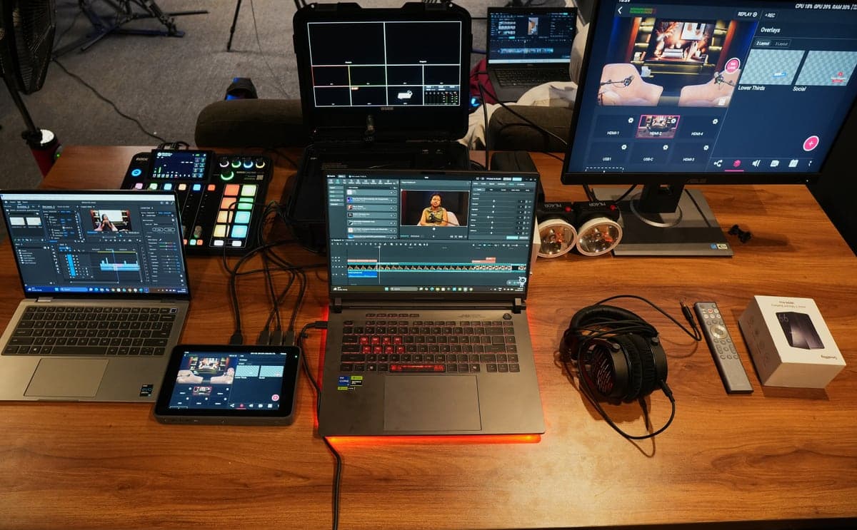 The production desk: RØDECaster sound desk, editing laptops, a multiview monitor and headphones